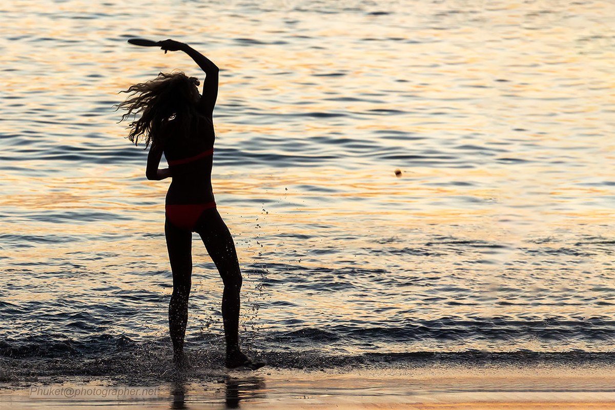 Silhouette of girl playing ball. Phuket island, Thailand XOKA9905bs
