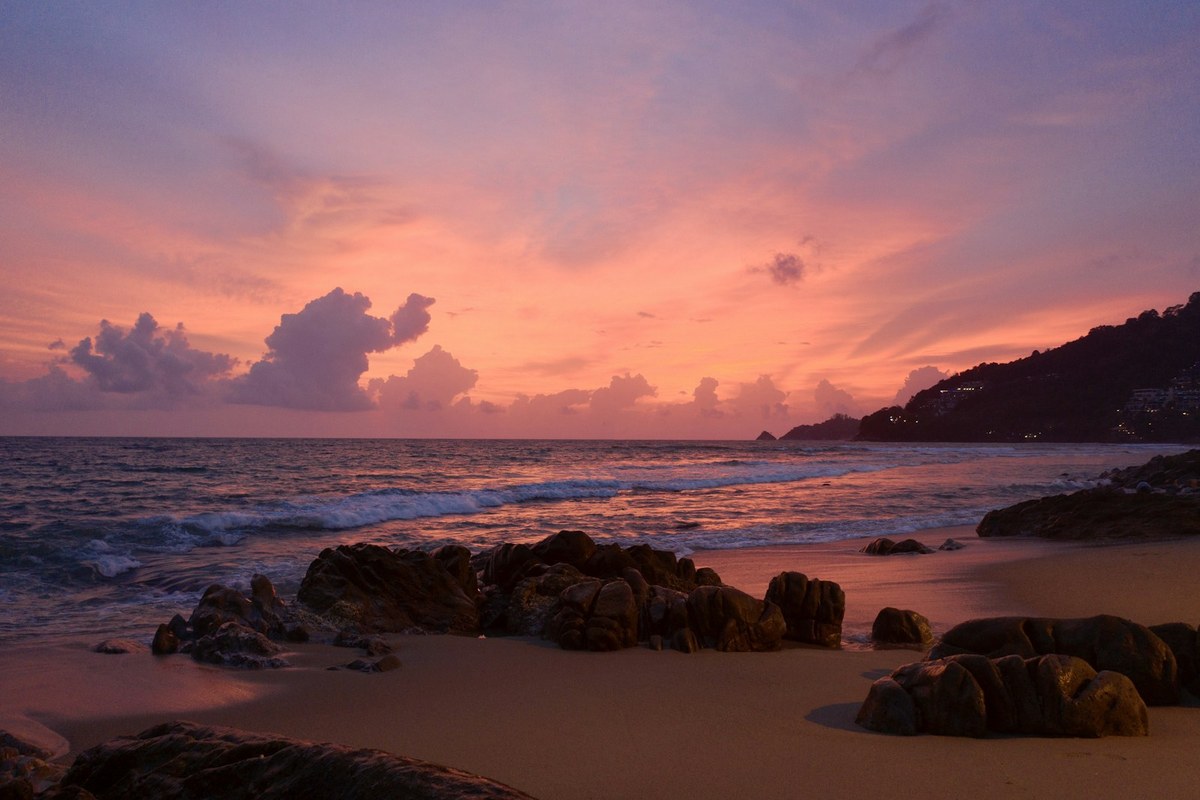 brown rocks on seashore during sunset