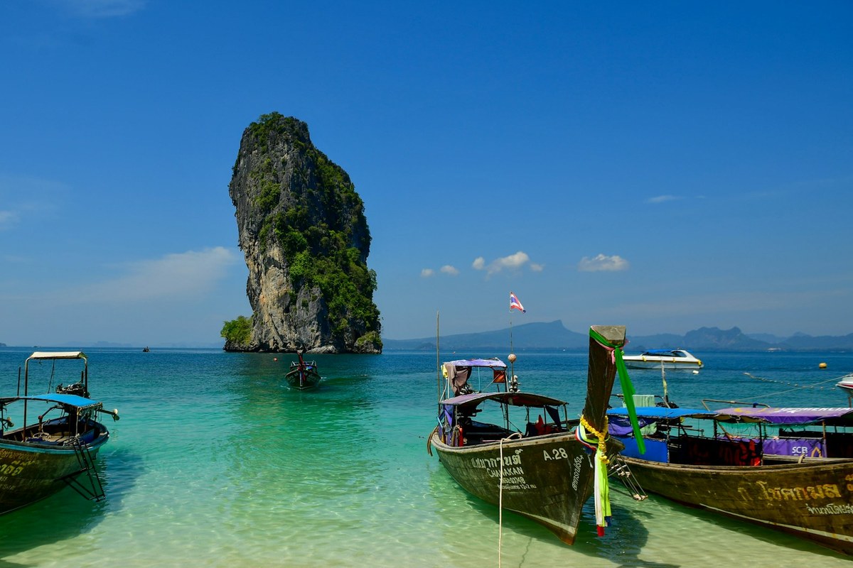 Longtail boats anchored near a tropical island